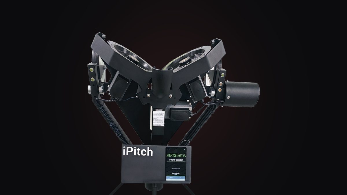 The iPitch machine head-on, its throwing wheels above the control box and mounted tablet