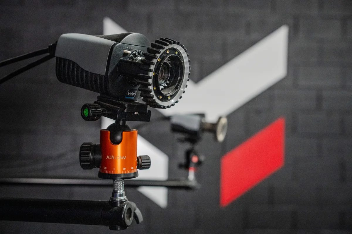 A Maven motion-capture camera on the lab rig, a second camera out of focus behind it